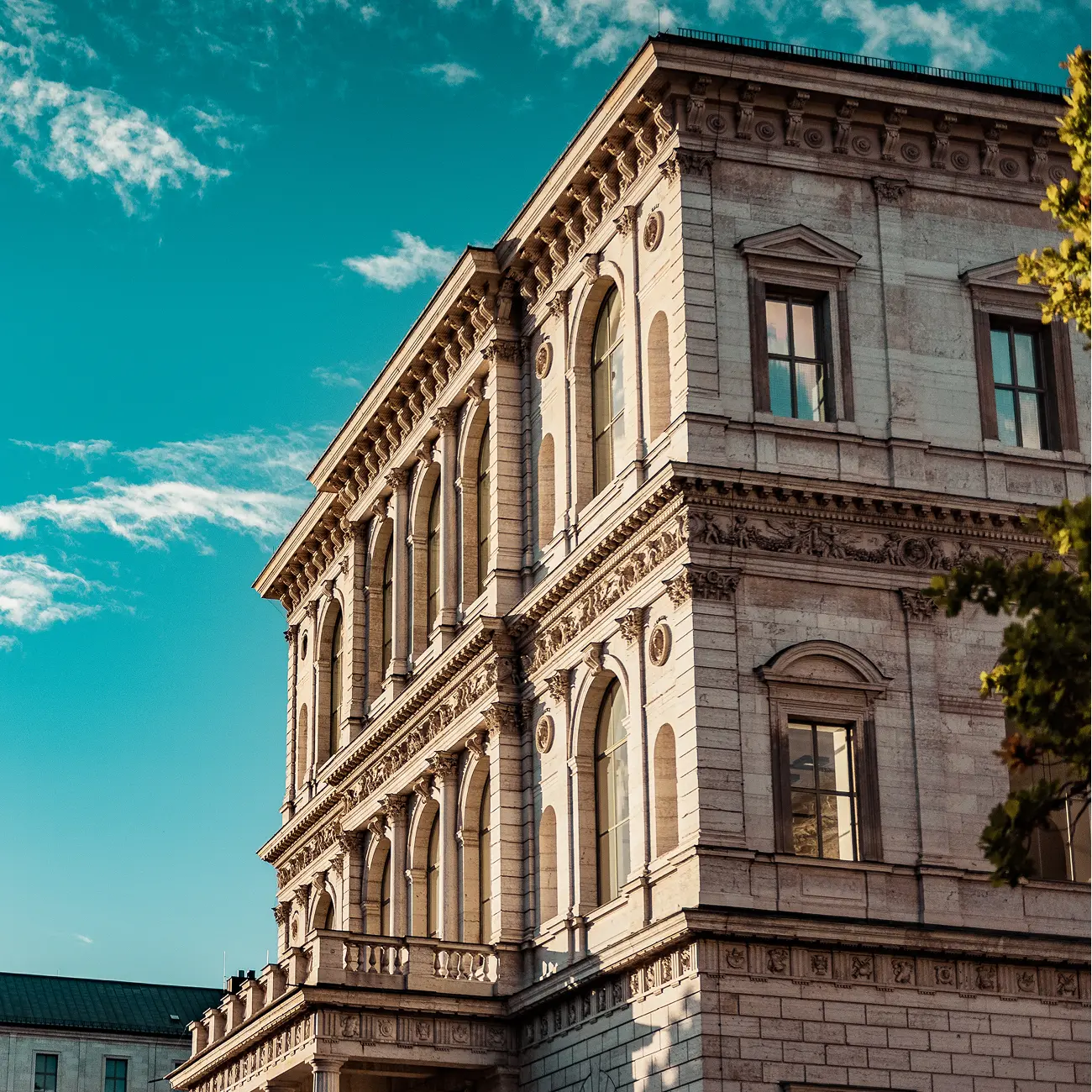 Historic stone building with arched windows and columns.