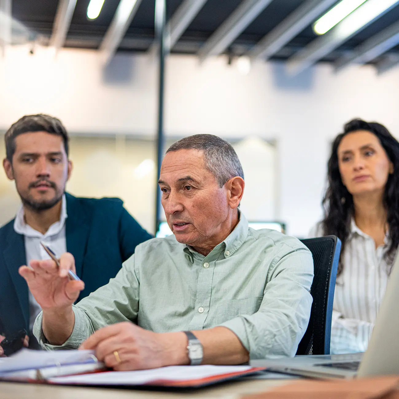 Business professionals discussing documents in a meeting.