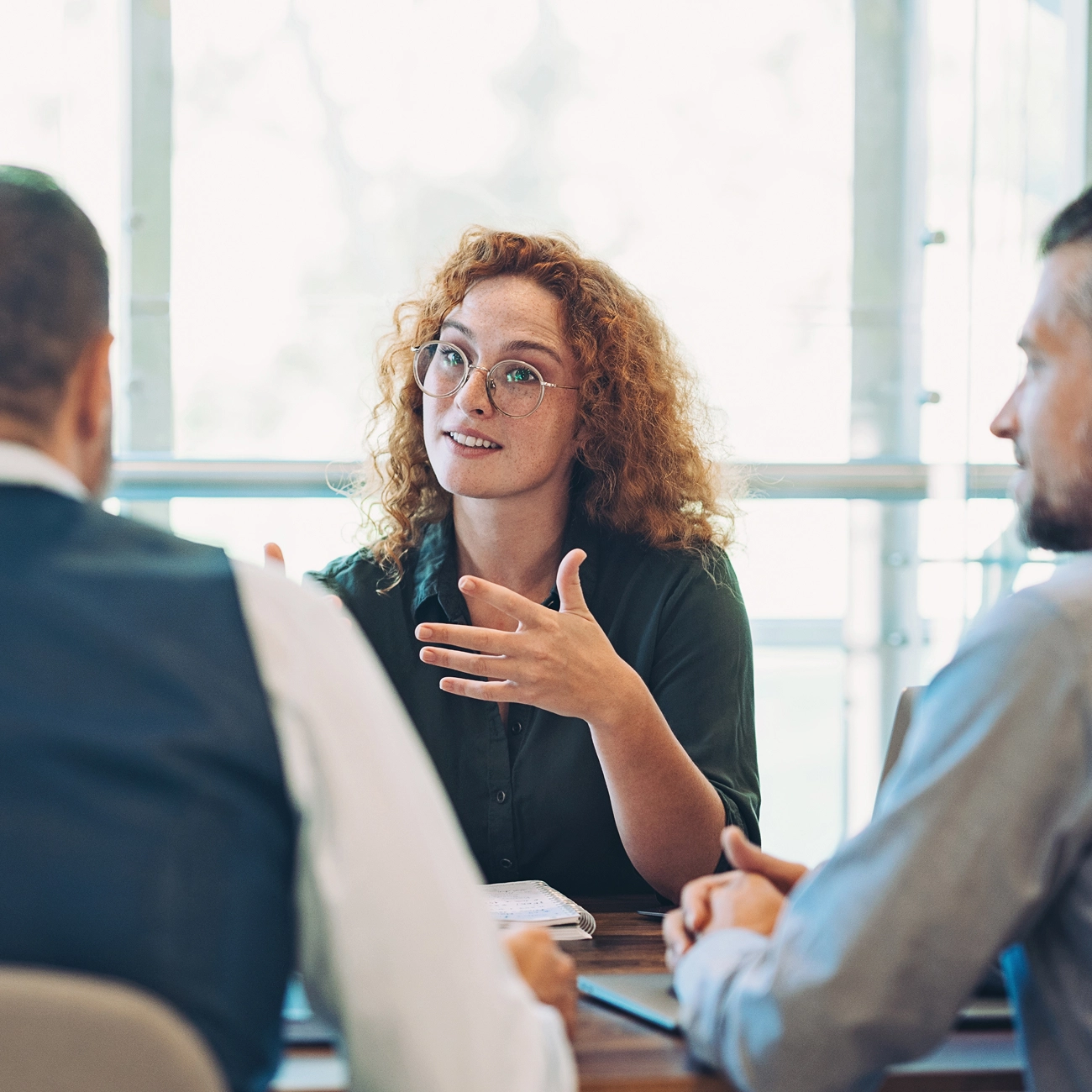 Woman speaking during a collaborative team meeting.