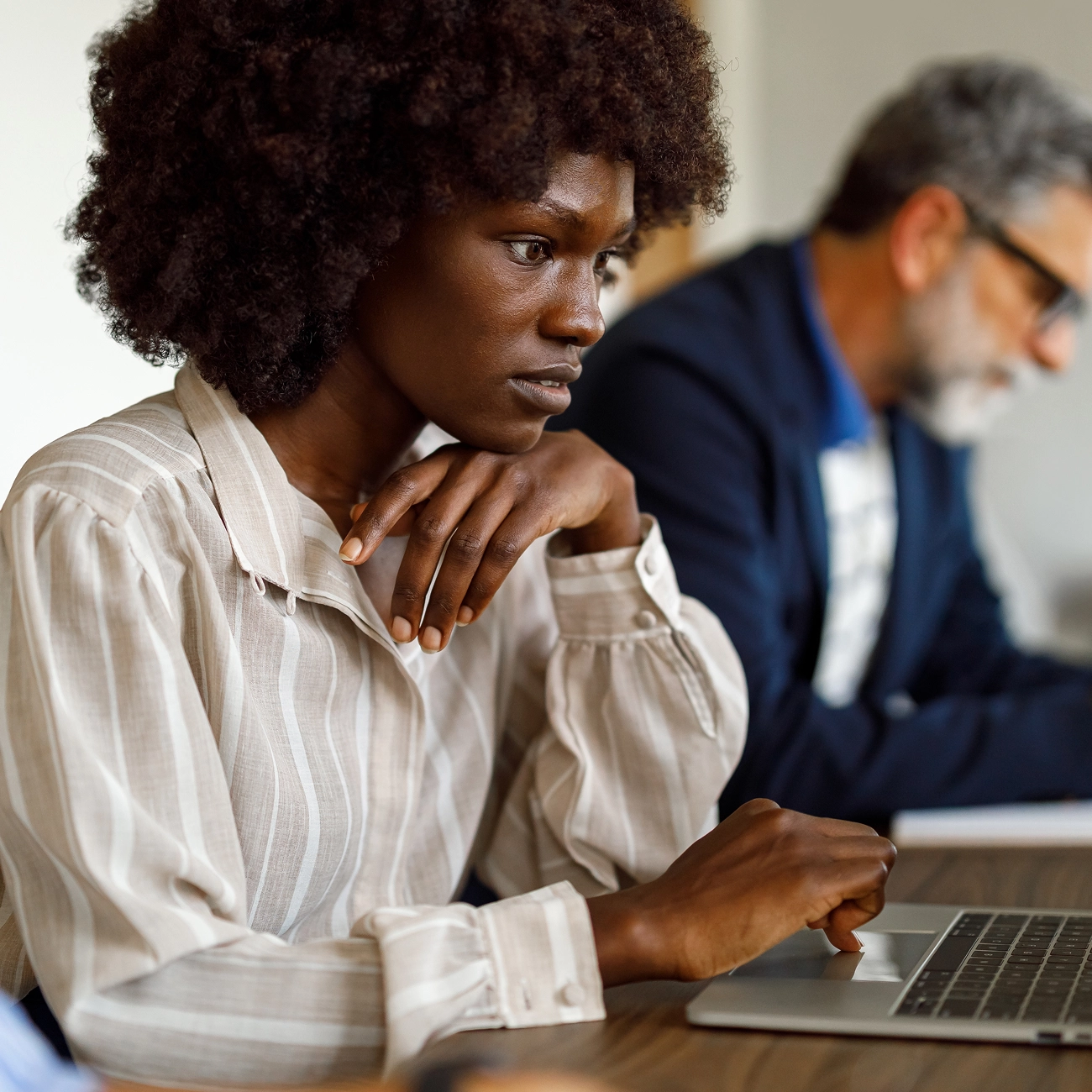 Professional analyzing information on a laptop.