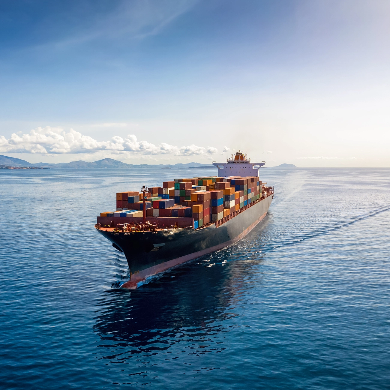 Large container cargo ship transporting goods at sea.