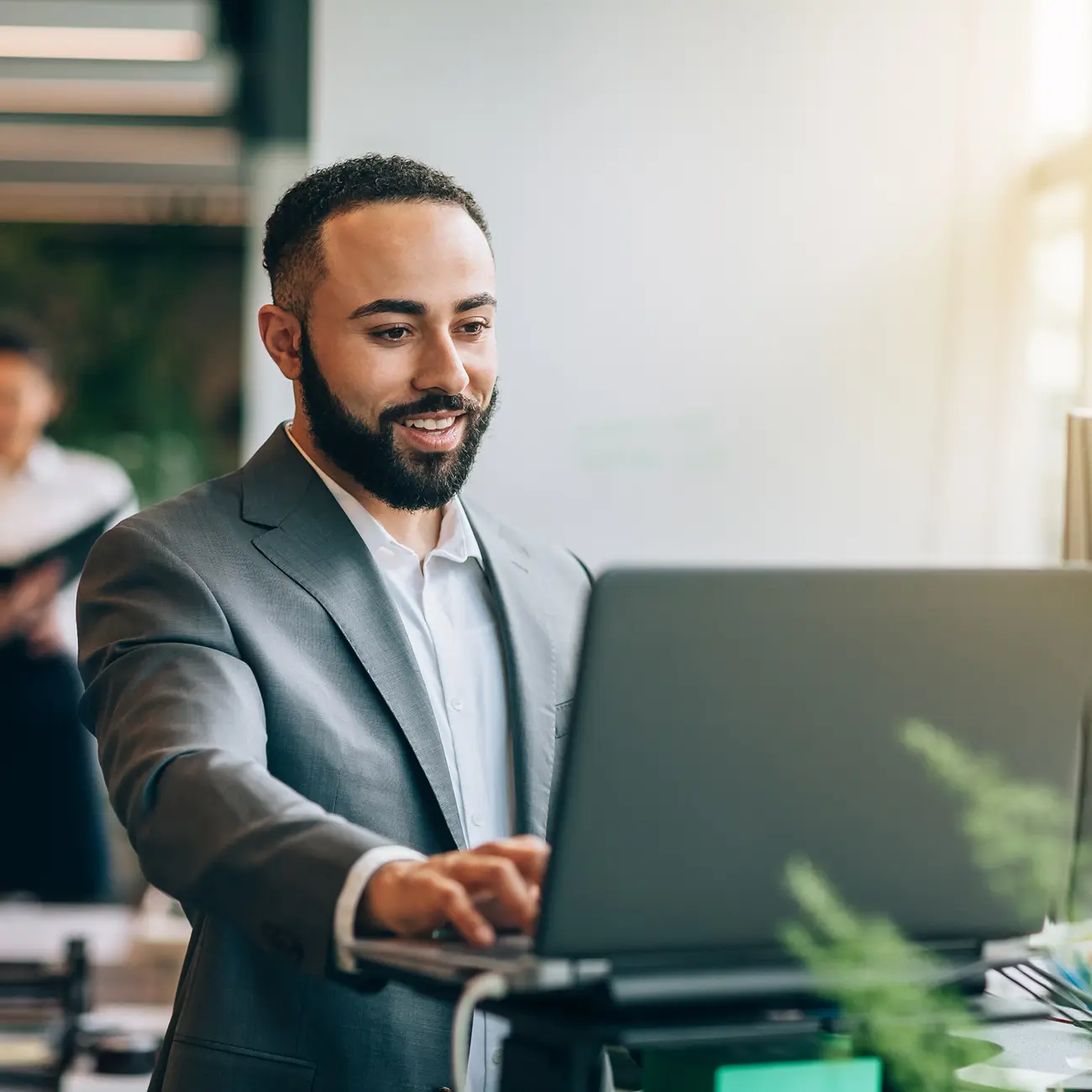 Man working on a laptop in an office.