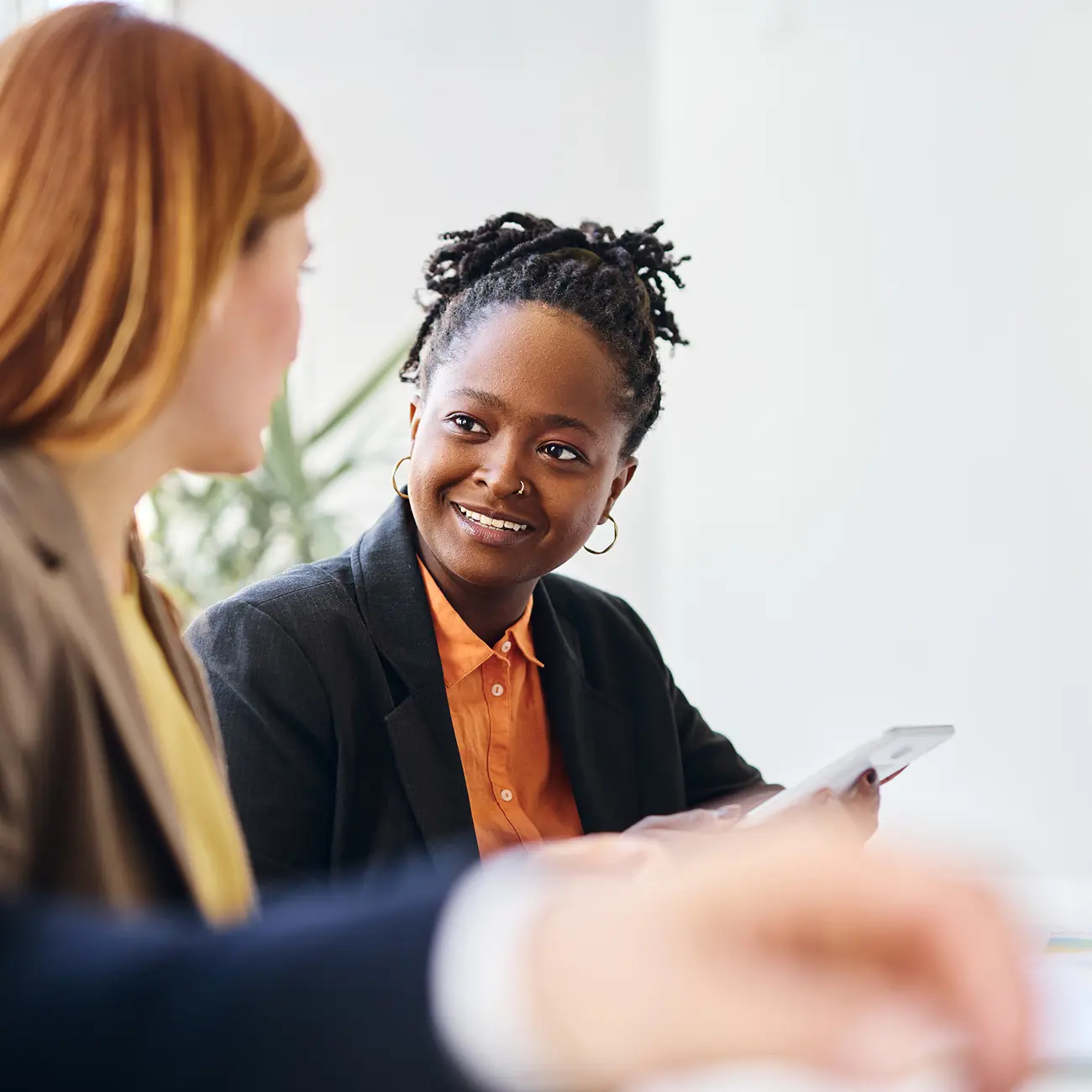 Two coworkers discussing information during a meeting.