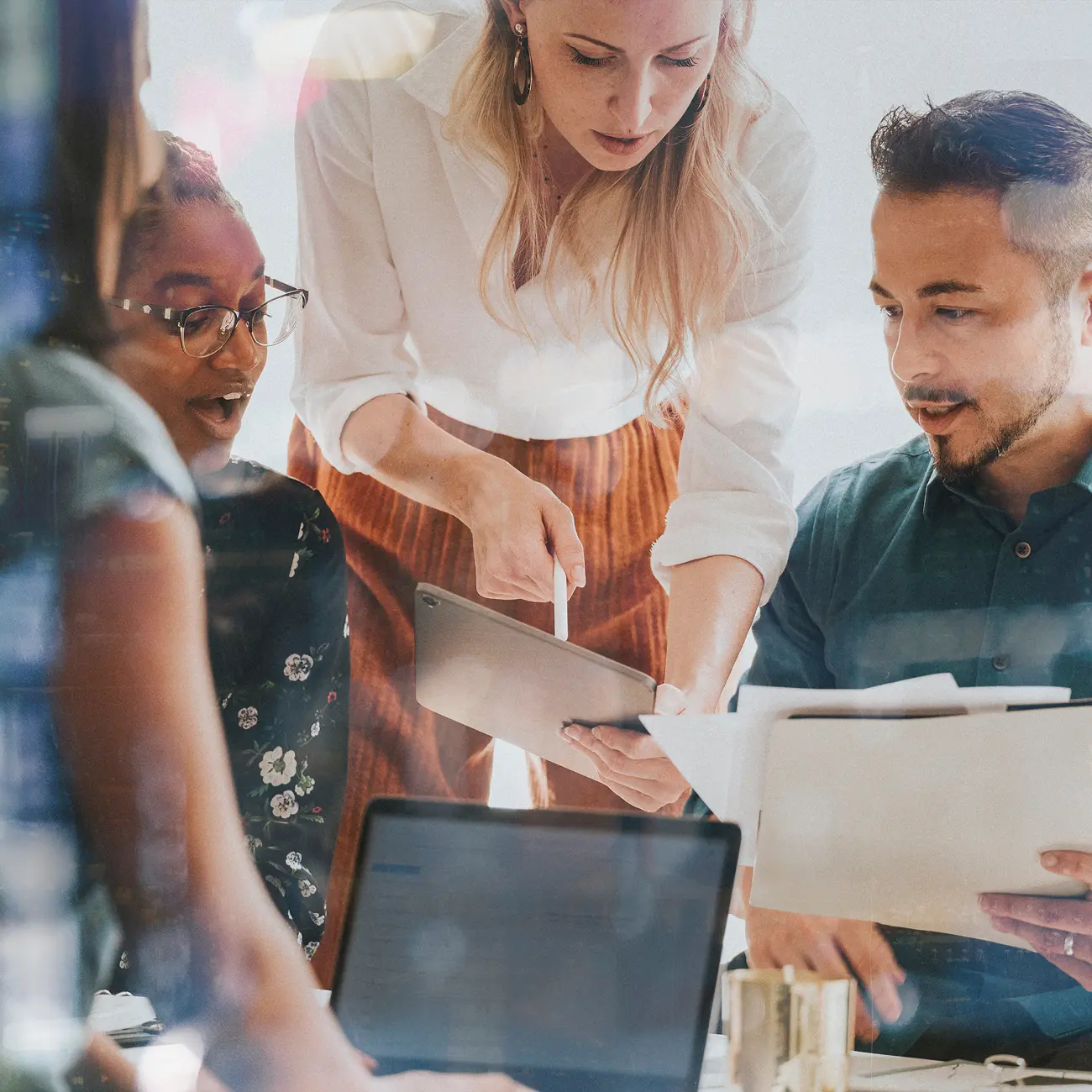 Team reviewing data on a tablet and documents.